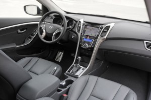 Interior looks upscale with faux aluminum trim, metallic pedals, and intuitive center stack