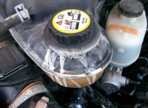 The white residue indicates that the coolant has boiled over - this can be caused by a faulty $5 radiator cap.