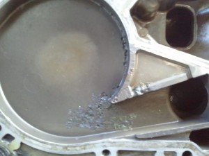 The pockmarks are the result of inappropriate coolant additives.  The coolant bubbled (cavitation), causing the metal housing to be eaten away.  Photo courtesy of Izzy351 at Ford-Trucks.com.